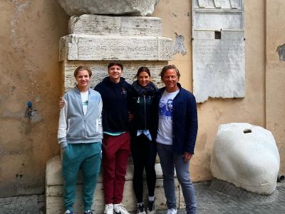 Melissa Tittl, Ray, Owen, and Will Jarell are posing in front of a monument.